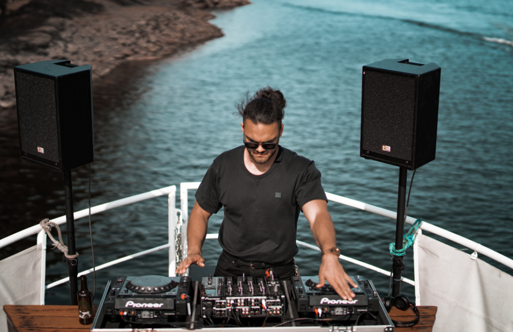 DJ derrière les platines sur la proue d'un bateau